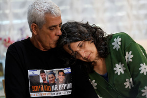 Yechi Yehoud kisses his wife Yael, as they speak to Reuters during an interview in their home in Rishon LeZion, Israel, February 6, 2024. Yehoud's son and daughter, Dolev and Arbel, were kidnapped in the deadly October 7 attack on Israel by the Palestinian Islamist group Hamas. Arbel Yehoud was taken hostage along boyfriend Ariel Cunio, whose brother David Cunio was also kidnapped during the attack. REUTERS/Susana Vera