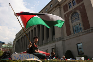 A student waves a flag during a march on Columbia University campus in support of a protest encampment supporting Palestinians, despite a 2pm deadline issued by university officials to disband or face suspension, during the ongoing conflict between Israel and the Palestinian Islamist group Hamas, in New York City, U.S., April 29, 2024. Photo: Reuters by Caitlin Ochs