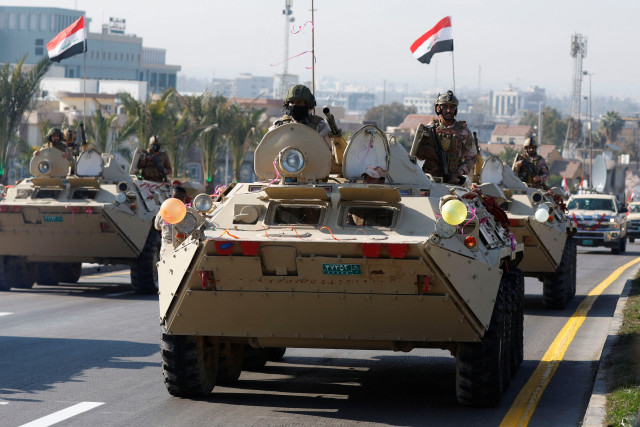 Iraqi soldiers ride military vehicles during a celebration of Iraq's "Victory Day", marking the historic defeat of Islamic State militants and the liberation of Iraqi territories, in Mosul, Iraq, December 10, 2024. Photo: Reuters Connect by Khalid Al-Mousily