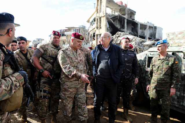 Lebanon's caretaker Prime Minister Najib Mikati, Lebanon's Army chief General Joseph Aoun and the Head of Mission and Force Commander of the United Nations Interim Force in Lebanon (UNIFIL) Aroldo Lazaro Saenz stand near rubble of damaged buildings from Israeli strikes, after the ceasefire between Israel and Hezbollah, during a visit to the Lebanese village of Khiam, December 23, 2024. REUTERS/Karamallah Daher