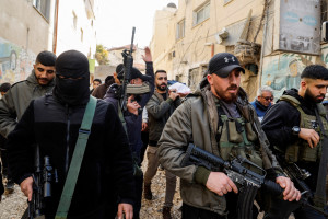 Men carry weapons during the funeral of Palestinian journalist Shatha Al Sabbagh, who was shot during clashes between Palestinian security forces and Palestinian militants, in Jenin refugee camp, in the Israeli-occupied West Bank, December 29, 2024. REUTERS/Raneen Sawafta