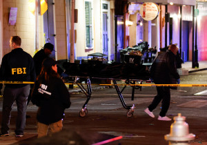 People carry a dead body in a body bag on a stretcher near the site where people were killed by a man driving a truck in an attack during New Year's celebrations, in New Orleans, Louisiana, U.S., January 2, 2025. REUTERS/Eduardo Munoz