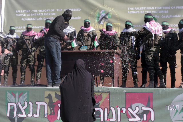 Four Israeli female soldiers are present as members of the International Committee of the Red Cross (ICRC) and Hamas sign documents for exchanges under the ongoing Gaza ceasefire agreement in Gaza City, Gaza, on January 25, 2025. (Photo by Momen Faiz/NurPhoto)