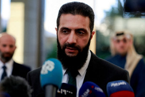 FILE PHOTO: FILE PHOTO: Syria's de facto leader Ahmed al-Sharaa, also known as Abu Mohammed al-Golani, speaks to the media during a meeting with Qatar's Minister of State Mohammed bin Abdulaziz Al-Khulaifi, after the ousting of Syria's Bashar al-Assad, in Damascus, Syria, December 23, 2024. REUTERS/Ammar Awad/File Photo/File Photo