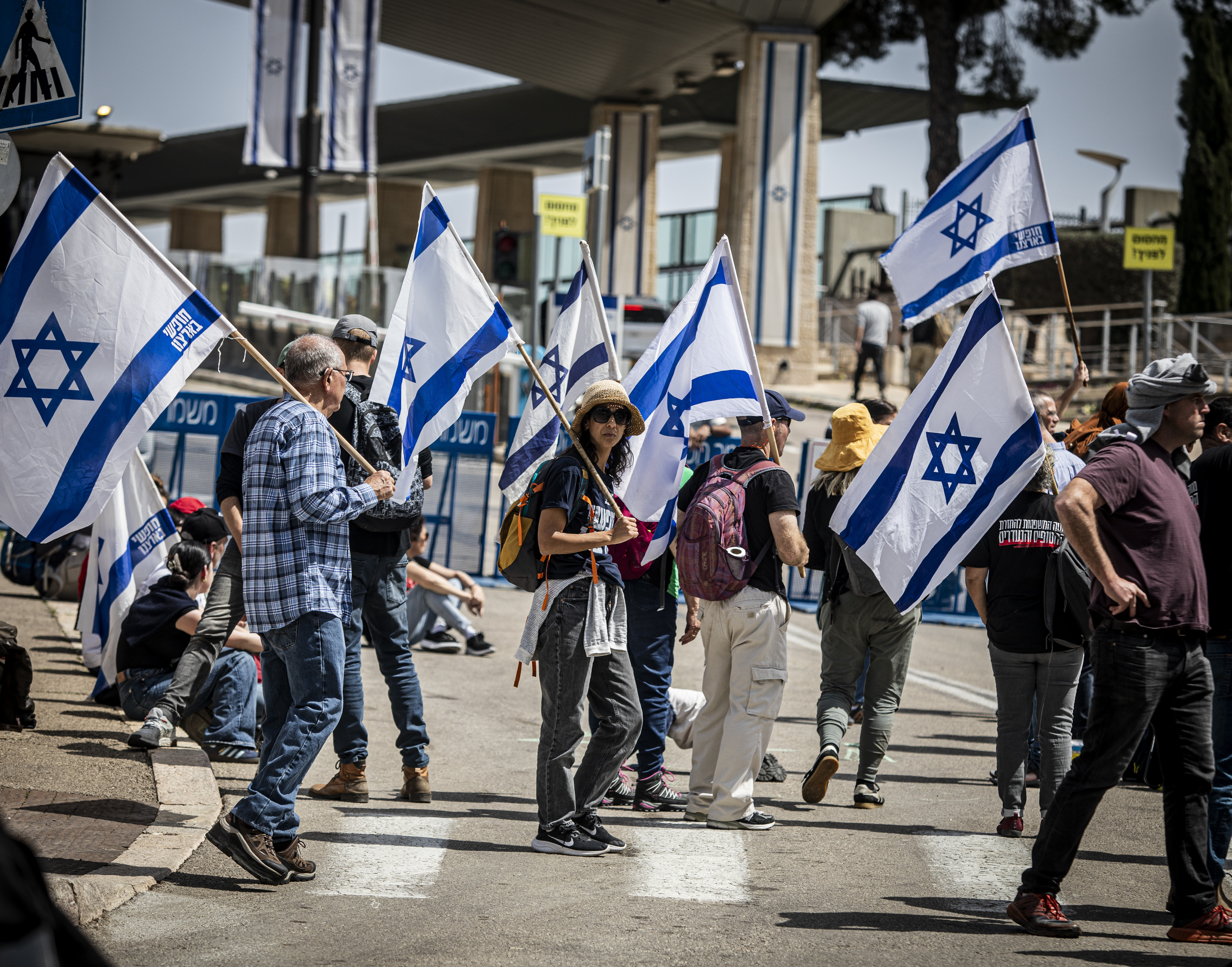 Israeli liberal protestors hold Israeli flags out side the Knesset Israel's Parliament during a third day of demonstrations. Eyal Warshavsky / SOPA Images via Reuters Connect