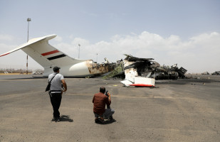 Members of the media take pictures of a destroyed plane at Sanaa International Airport, in the aftermath of an Israeli airstrike, in Sanaa, Yemen, May 7, 2025. REUTERS/Khaled Abdullah
