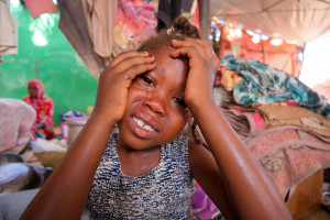 The sister's daughter of Al-Rasheed Al-Tahir, a displaced Sudanese man, cries after hearing her mother's story, after the family fled the war-torn al-Fashir city, as the humanitarian situation deteriorates amid the ongoing conflict between the paramilitary Rapid Support Forces (RSF) and the Sudanese army, at a displacement camp in Al Dabba, Sudan, September 6, 2025. REUTERS/El Tayeb Siddig