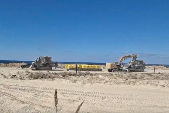 A screengrab from a handout video shows Israeli military vehicles moving barrier blocks to mark the "Yellow Line", in location given as Gaza, released on October 20, 2025. Photo: Israel's Ministry of Defence via Reuters Connect