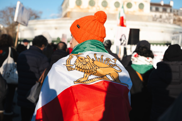 A supporter of the uprising in Iran carries a flag with the lion, the ancient flag of Iran and Persia. January 4, 2025 Photo: Vincent Koebel via Reuters Connect
