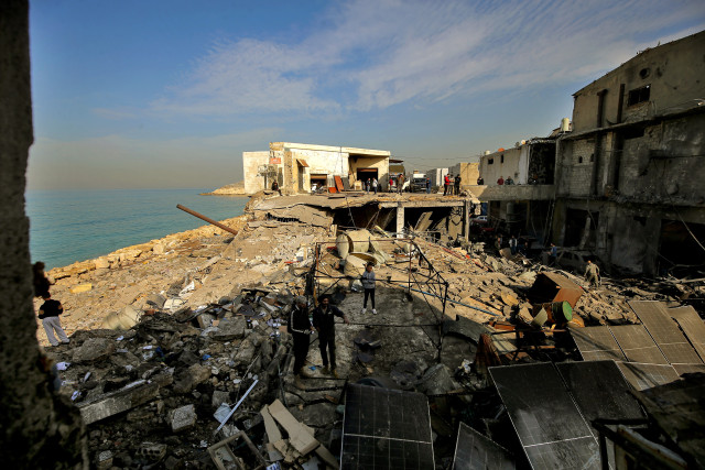 People inspect damage caused by an overnight Israeli air raid in the industrial area of Ghazieh on the outskirts of the southern Lebanese port city of Sidon. Israeli military launched strikes on southern and eastern parts Lebanon after warning it would hit what it called pro-Iranian Hezbollah and Palestinian Hamas targets, January 6, 2026 Photo: Marwan Naamani/ZUMA Press Wire via Reuters Connect