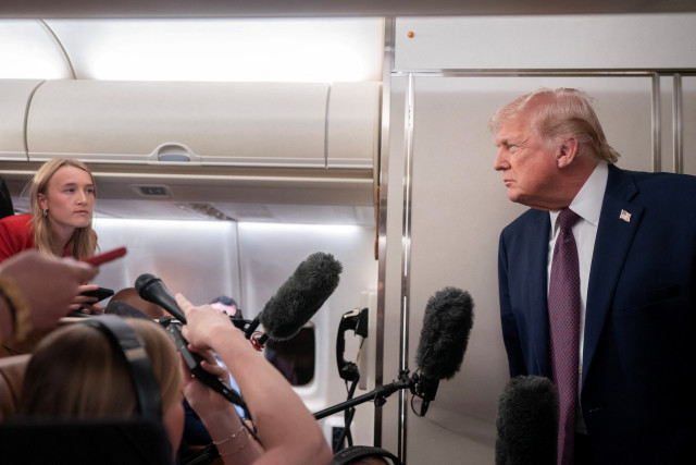 U.S. President Donald Trump speaks with members of the media aboard Air Force One en route from Florida to Joint Base Andrews, Maryland, U.S., January 11, 2026. Photo: Reuters Connect by Nathan Howard