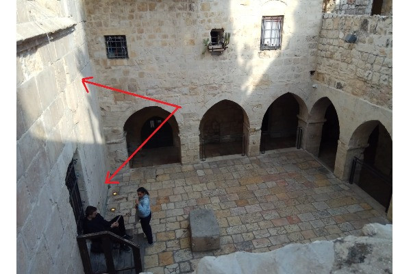 The building seen and shown to the left is holding the upper room at the second floor, and the traditional place of the Tomb of David underneath. The first large stone layers of the building (Shown by red arrows) are dated by many to the first building, a church or a synagogue, or both, during the 1st to 2nd century A.D. Picture from March 27, 2019 (Photo: Aaron Goel-Angot).