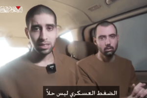 Evyatar David and Guy Gilboa-Dalal watch the broadcast of the release of fellow Israeli hostages in Nuseirat, central Gaza, on February 22, 2025. Photo: Screenshot from a video released by Hamas.