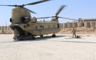 A Task Force Phoenix CH-47 Chinook helicopter from B Company, 1st Battalion, 171st Aviation Regiment (General Support Aviation Battalion), sits on the landing pad at a forward operating base in Syria. (Photo: Jason Sweeney/U.S. Army)