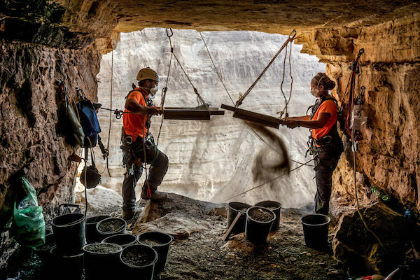 Archaeologists Hagay Hamer and Oriah Amichai sieving finds at the entrance to the Cave of Horror. Photo: Eitan Klein, Israel Antiquities Authority