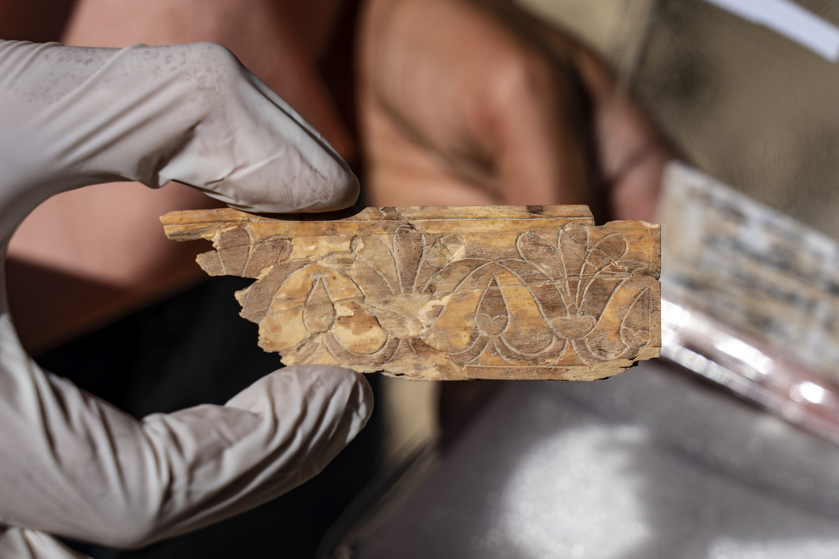 Ivory plaque decorated with a lotus flower. Photo: Yaniv Berman, Israel Antiquities Authority
