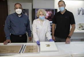 Raz Frohlich, Director General of the Ministry of Culture and Sports, Tanya Bitler, Scroll Conservationist at the Israel Antiquities Authority and Avi Cohen, the Director General of the Ministry of Jerusalem Affairs and Heritage, examining the discovered scroll fragments. (Photo: Shai Halevi/Israel Antiquities Authority)