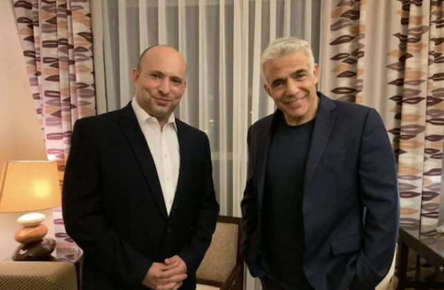 Yamina leader and Prime Minister-designate Naftali Bennett and Yesh Atid leader Yair Lapid after announcing the formation of a new coalition, June 3, 2021. (Photo: Yesh Atid handout)