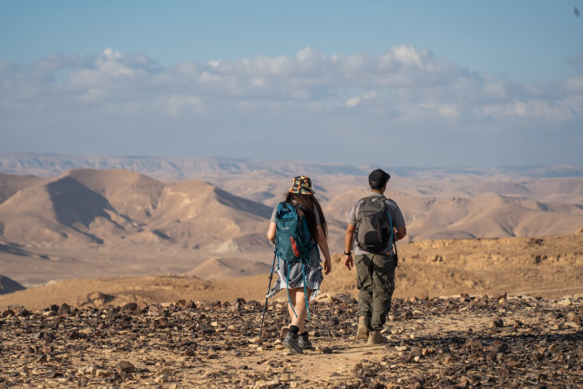 Travelers hike in Har Karkom, in the southwest Negev desert, on December 21, 2022. Photo by Yaniv Nadav/Flash90