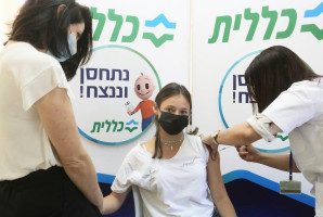 Prime Minister Naftali Bennett's daughter Michal Bennett, 14, accompanied by her mother, Gilat, receives her COVID vaccine on June 29, 2021. (Photo: Nimrod Glickman, Clalit Health Services (Sharon-Samaria District) Spokesperson's Office)