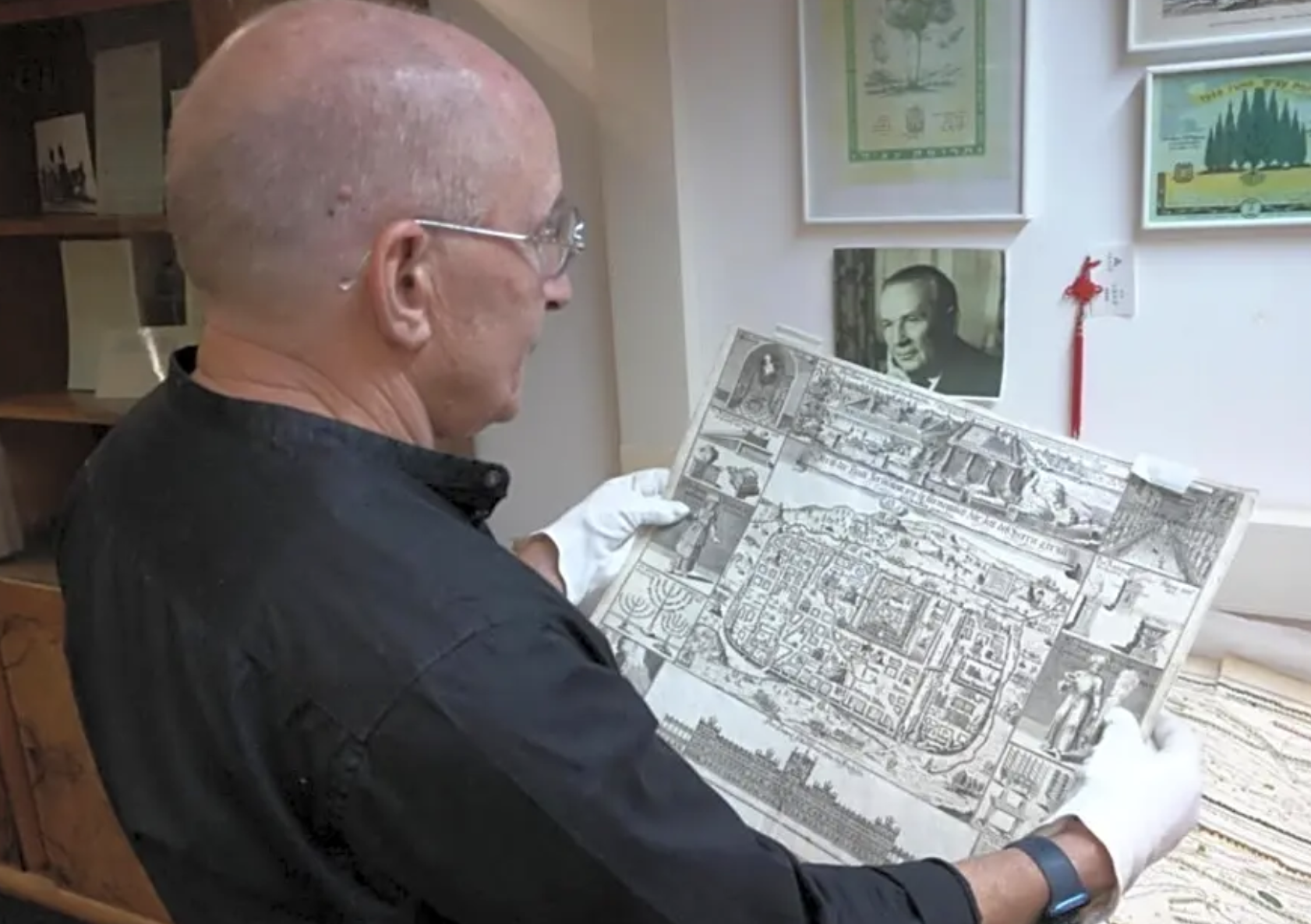 A researcher holds a drawing from the Umansky Collection (Photo: Haifa University)