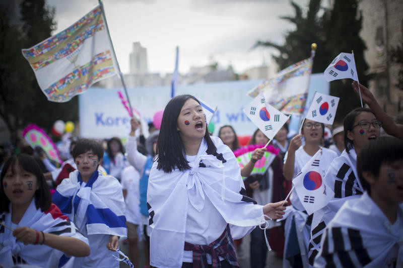 A Christian Evangelical supporter waves her national flag during the annual parade in Jerusalem, marking the Jewish holiday of Sukkot or the Feast of the Tabernacles. September 24, 2013. The parade take place every year in the holiday of Sukkot, with many delegations from Israel and abroad, and they march through the streets of center Jerusalem and lots of spectators from around the country come to see it. Photo by Yonatan Sindel/Flash90