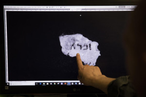 maging technician and camera operator, Shay Halevy, shows on screen fragments of a newly discovered script found by Israel Antiquities Authority researcher, Oren Abelman, in "Cave 11" near Qumran, at the IAA department in the Israel Museum, Jerusalem, on May 2, 2018. The fragments are now readable through advanced imaging equipment which can reveal letters that are invisible to the naked eye, at the Dead Sea Scrolls' conservation labs of the authority. Photo by Hadas Parush/Flash90