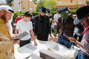 Jews read the Megillat Esther (the Story of Esther) during the Jewish holiday of Purim, in Katzrin, northern Israel, March 7, 2023 (Photo: Michael Giladi/Flash90).
