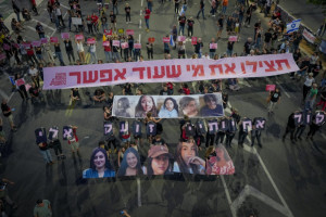 Demonstrators hold images of five female soldiers held hostage by Hamas terrorists in Gaza. The banner in Hebrew reads: "Save those who can still be saved." The protest was outside the Ministry of Defense in Tel Aviv, May 25, 2024 (Photo: Erik Marmor/Flash90).