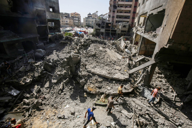 Palestinians amid destruction in Nuseirat camp in the central Gaza Strip, on June 8, 2024. Photo by Khaled Ali/Flash90