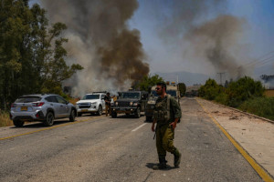 Israeli soldiers at the site where a large fire started from missiles launched from Lebanon near Kibbutz Kfar Szold, northern Israel, June 14, 2024 (Photo: Ayal Margolin/Flash90).