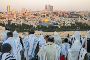 Jewish men cover with prayer shwals during Sukkot at a lookout of the Mount of Olives, overlooking the Old city of Jerusalem on October 23, 2024. Photo by Yonatan Sindel/Flash90