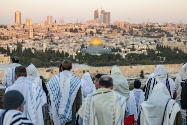 Jewish men cover with prayer shwals during Sukkot at a lookout of the Mount of Olives, overlooking the Old city of Jerusalem on October 23, 2024. Photo by Yonatan Sindel/Flash90