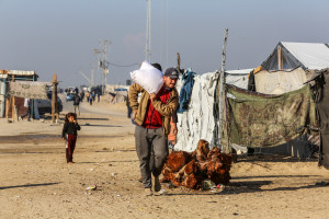 Palestinians receive bags of flour at the United Nations Relief and Works Agency for Palestinian Refugees (UNRWA) distribution center, in Hamad City, north of Khan Younis in the southern Gaza Strip, December 3, 2024. Photo by Abed Rahim Khatib/Flash90