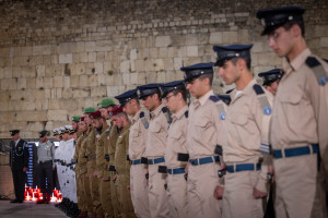 Israeli soldiers stand at attention by the Israeli flag at half mast during a Memorial Day ceremony at the Western Wall, Judaism's holiest site, in Jerusalem's Old City, April 29, 2025, as Israel commemorates its fallen soldiers and victims of terror. Photo by Chaim Goldberg/Flash90