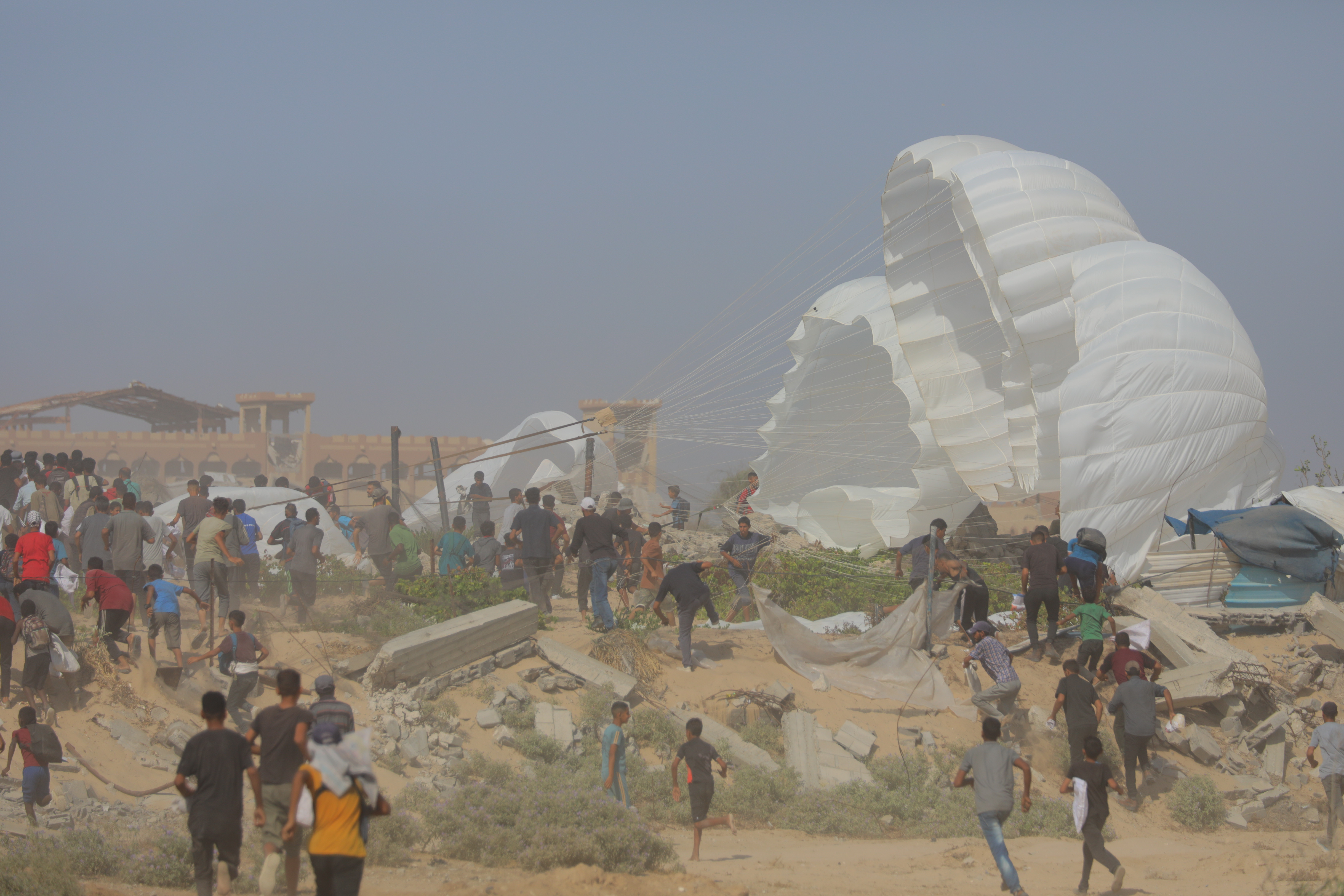Palestinians at the site where parachuted aid packages landed in Gaza City, August 15, 2025. Photo by Ali Hassan/Flash90