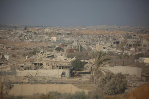 People walk near destroyed buildings following an Israeli airstrike in Gaza City, September 16, 2025, after Israel launched a large-scale operation in the city. Photo by Ali Hassan/Flash90