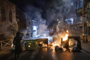 Ultra-Orthodox Jewish men block a road and clash with police during a protest against the autopsy of toddlers who died earlier in a daycare, in Jerusalem, January 19, 2026. Photo by Chaim Goldberg/Flash90