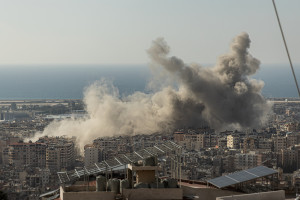 Dust rises above Beirut's Dahiyeh suburb after multiple Israeli airstrikes destroyed apartment buildings on Nov. 12, 2024. 
Photo by Collin Mayfield/Sipa USA via Reuters Connect