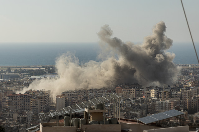 Dust rises above Beirut's Dahiyeh suburb after multiple Israeli airstrikes destroyed apartment buildings on Nov. 12, 2024. 
Photo by Collin Mayfield/Sipa USA via Reuters Connect