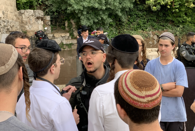 Police arguing with youth (Photo: All Israel News)