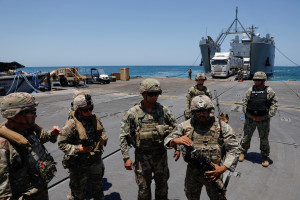 Soldiers stand at Trident Pier, a temporary pier to deliver aid, off the Gaza Strip, amid the ongoing conflict between Israel and Hamas, near the Gaza coast, June 25, 2024. 
REUTERS/Amir Cohen