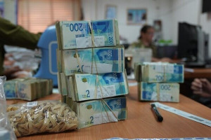 Cash seized by the IDF in the Gaza Strip is seen being counted before being deposited at the Bank of Israel, April 18, 2024. Photo: (Defense Ministry)