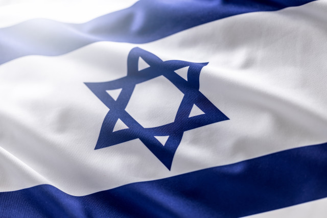 Israeli flag blowing in the wind - Close up. Photo: Shutterstock
